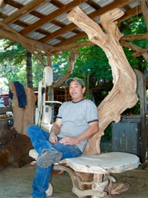 Larry Shinerock in his outdoor workshop at "It's A Burl" wood gallery in Kirby, Oregon. 