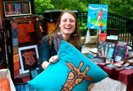 Melissa Orion, a new artist at Lithia Artisans Market of Ashland, in her colorful booth of beautiful, fun, original, archetypal art pieces.