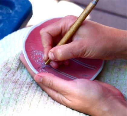 Lisa Eldredge, hands working clay with simple tools at the Lithia Artisans Market of Ashland Oregon.