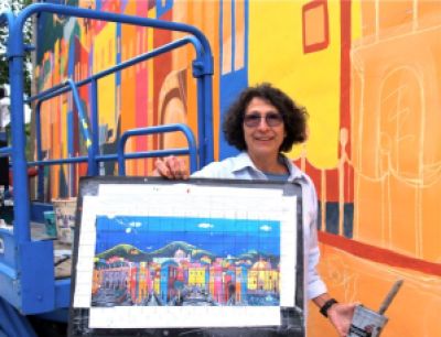 Loreta Rangel Villasenor is a Fine Artist from Guanajuato, GTO., Mexico. She has just begun the painting of a large mural on a wall that is shared with the Lithia Artisans Market of Ashland, Oregon. 